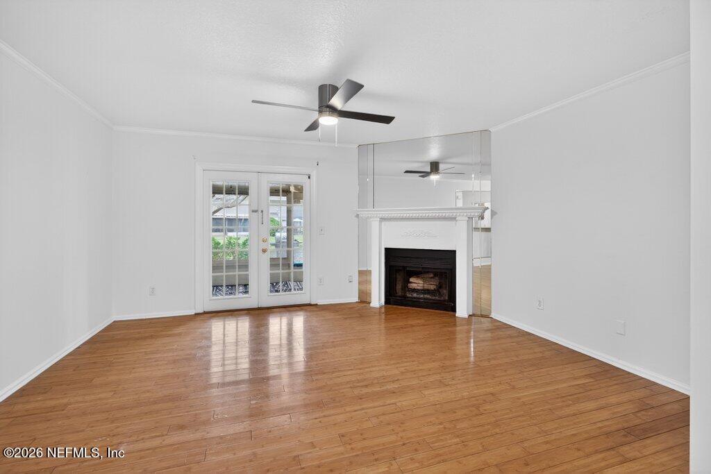 3801 Crown Point Road, Unit 2072 Jacksonville, FL 32257 - Photo 22 of 38 a view of an empty room with wooden floor fireplace and a window