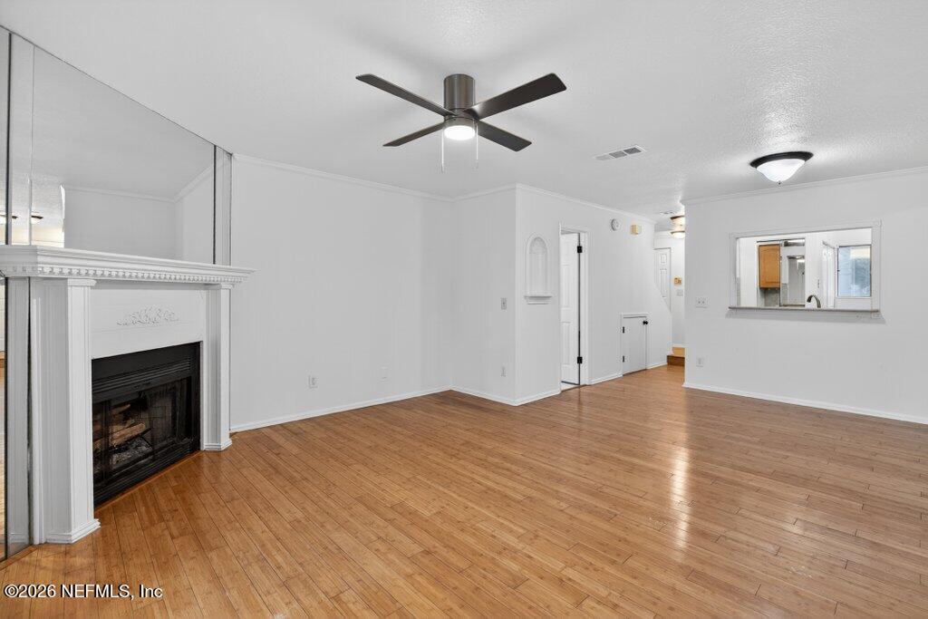 3801 Crown Point Road, Unit 2072 Jacksonville, FL 32257 - Photo 23 of 38 a view of empty room with wooden floor and a fireplace