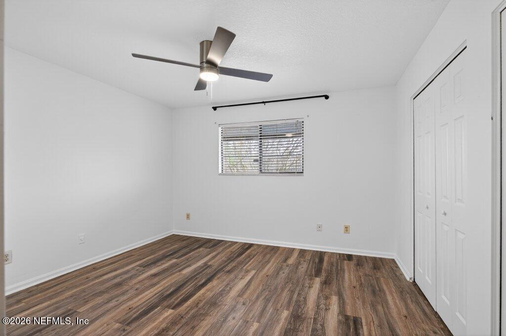 3801 Crown Point Road, Unit 2072 Jacksonville, FL 32257 - Photo 30 of 38 an empty room with a hardwood and ceiling fan