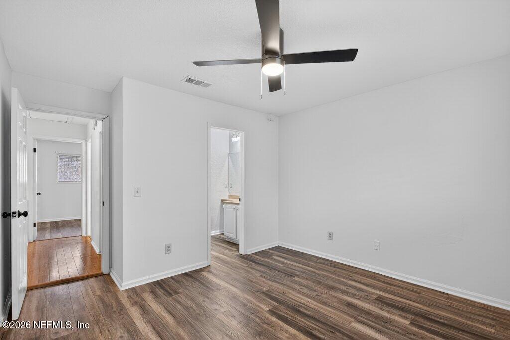 3801 Crown Point Road, Unit 2072 Jacksonville, FL 32257 - Photo 31 of 38 a view of an empty room with wooden floor and a window