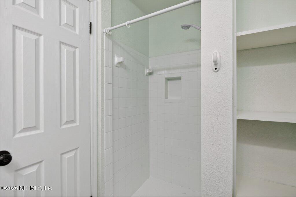 3801 Crown Point Road, Unit 2072 Jacksonville, FL 32257 - Photo 34 of 38 a bathroom with a glass shower door