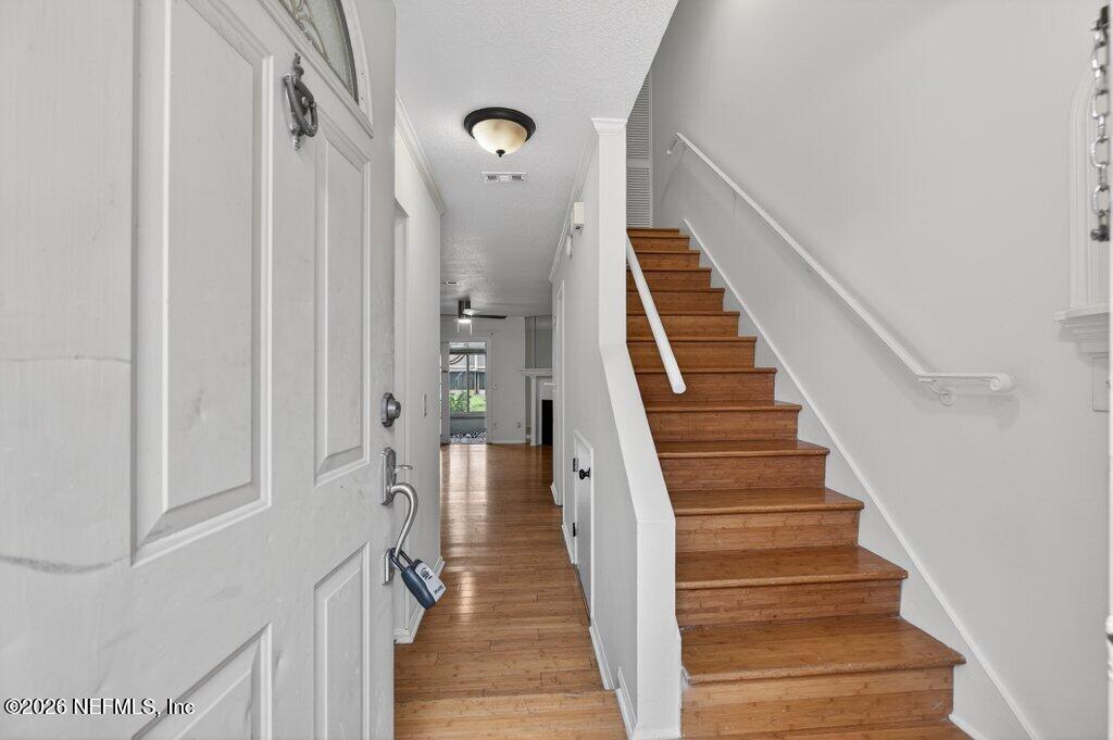 3801 Crown Point Road, Unit 2072 Jacksonville, FL 32257 - Photo 8 of 38 a view of staircase with wooden floor and white walls