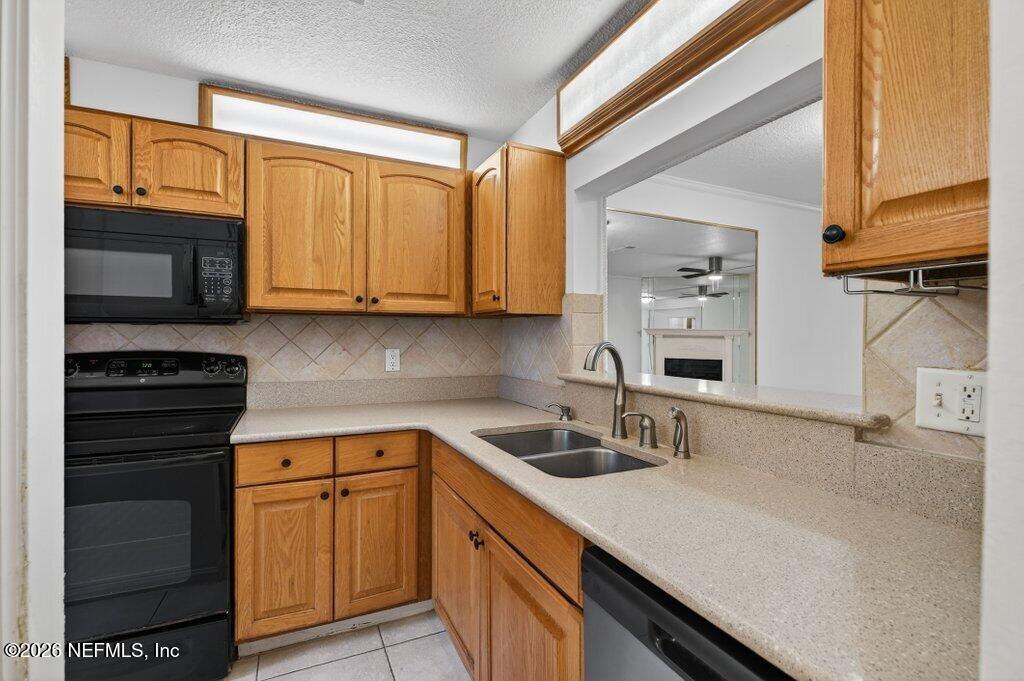 3801 Crown Point Road, Unit 2072 Jacksonville, FL 32257 - Photo 10 of 38 a kitchen with stainless steel appliances granite countertop a sink stove and microwave