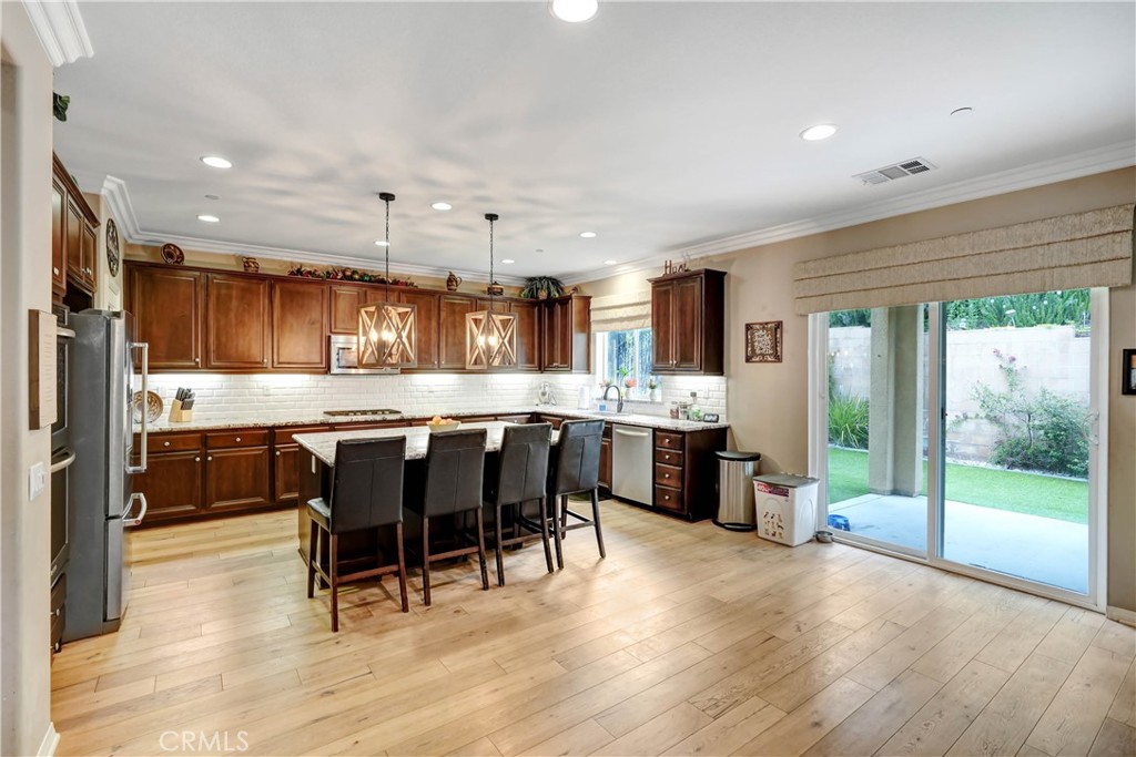 44260 Nighthawk Pass Temecula, CA 92592 - Photo 13 of 55 a large kitchen with a table and chairs