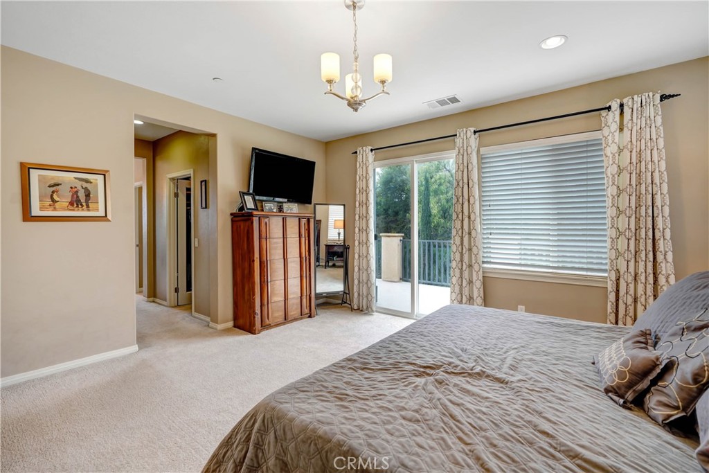 44260 Nighthawk Pass Temecula, CA 92592 - Photo 20 of 55 a bed room with a bed mirror and a window