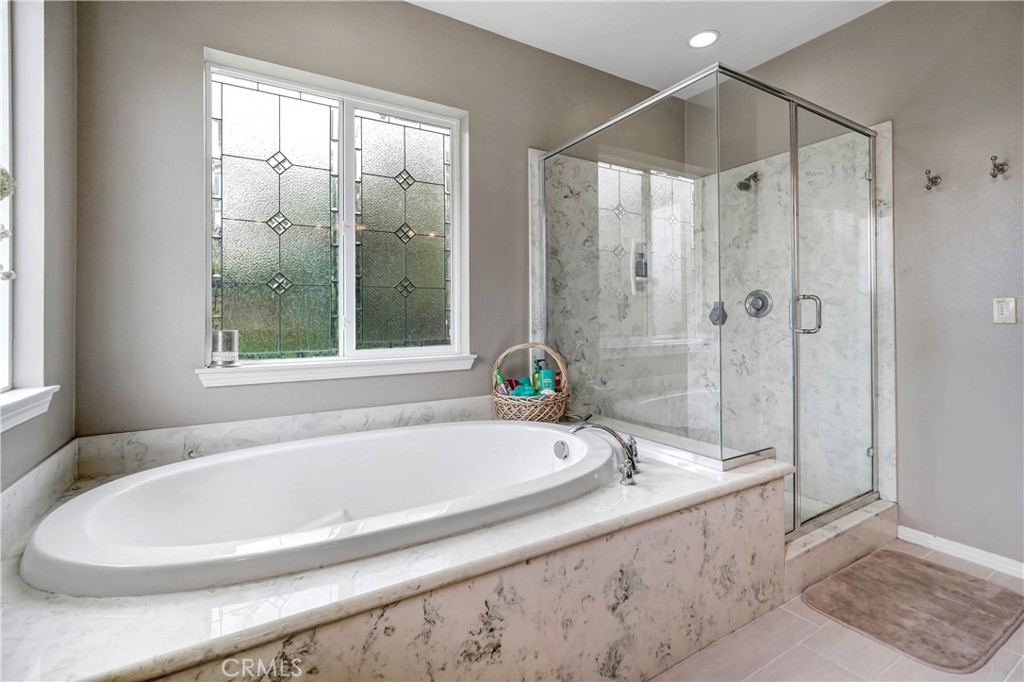 44260 Nighthawk Pass Temecula, CA 92592 - Photo 23 of 55 a white bath tub sitting next to a shower