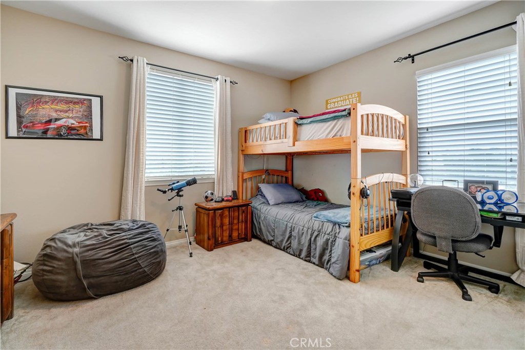 44260 Nighthawk Pass Temecula, CA 92592 - Photo 26 of 55 a bedroom with a bed and a chandelier