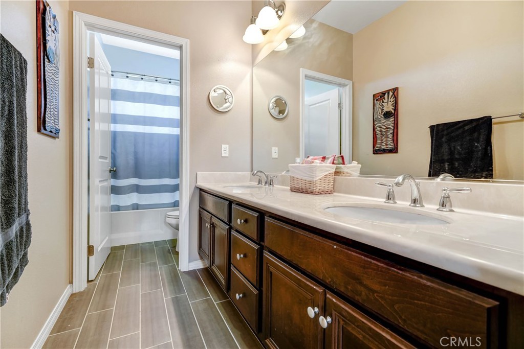 44260 Nighthawk Pass Temecula, CA 92592 - Photo 27 of 55 a bathroom with a double vanity sink and a mirror