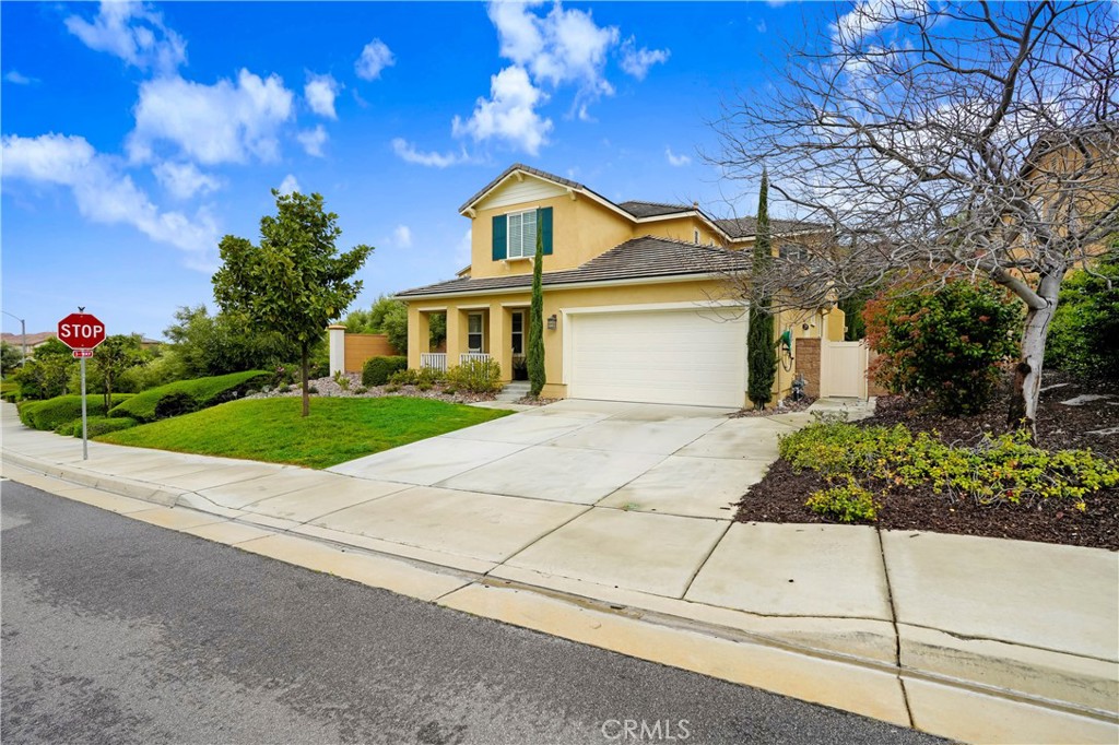 44260 Nighthawk Pass Temecula, CA 92592 - Photo 44 of 55 a front view of a house with a yard and garage