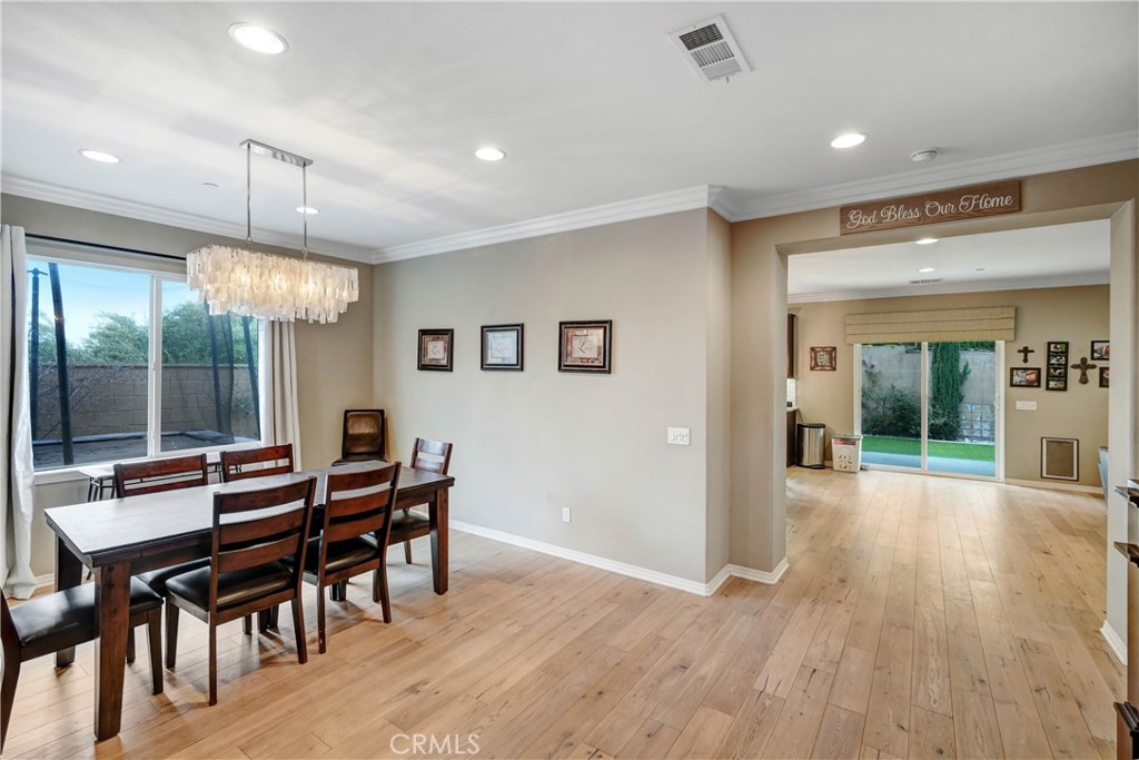 44260 Nighthawk Pass Temecula, CA 92592 - Photo 7 of 55 a view of a dining room with furniture window and wooden floor