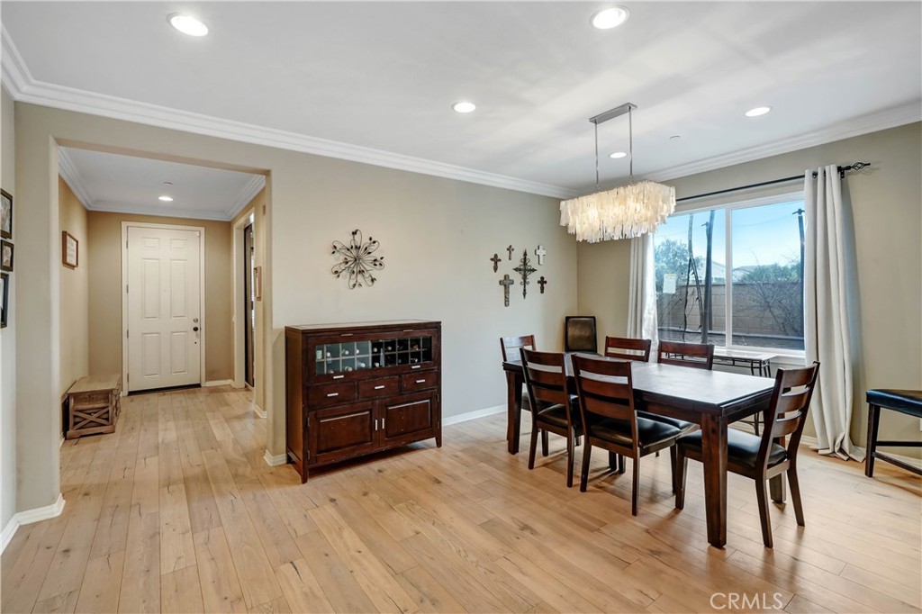 44260 Nighthawk Pass Temecula, CA 92592 - Photo 8 of 55 a view of a a dining room with furniture window and wooden floor