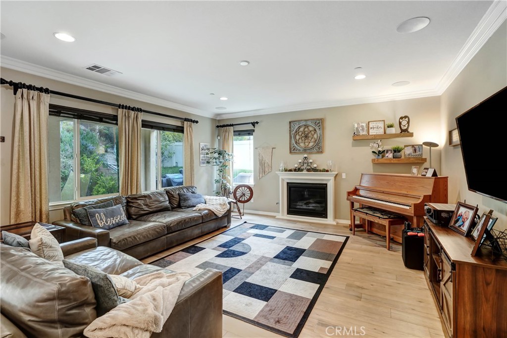 44260 Nighthawk Pass Temecula, CA 92592 - Photo 10 of 55 a living room with furniture a flat screen tv and a fireplace