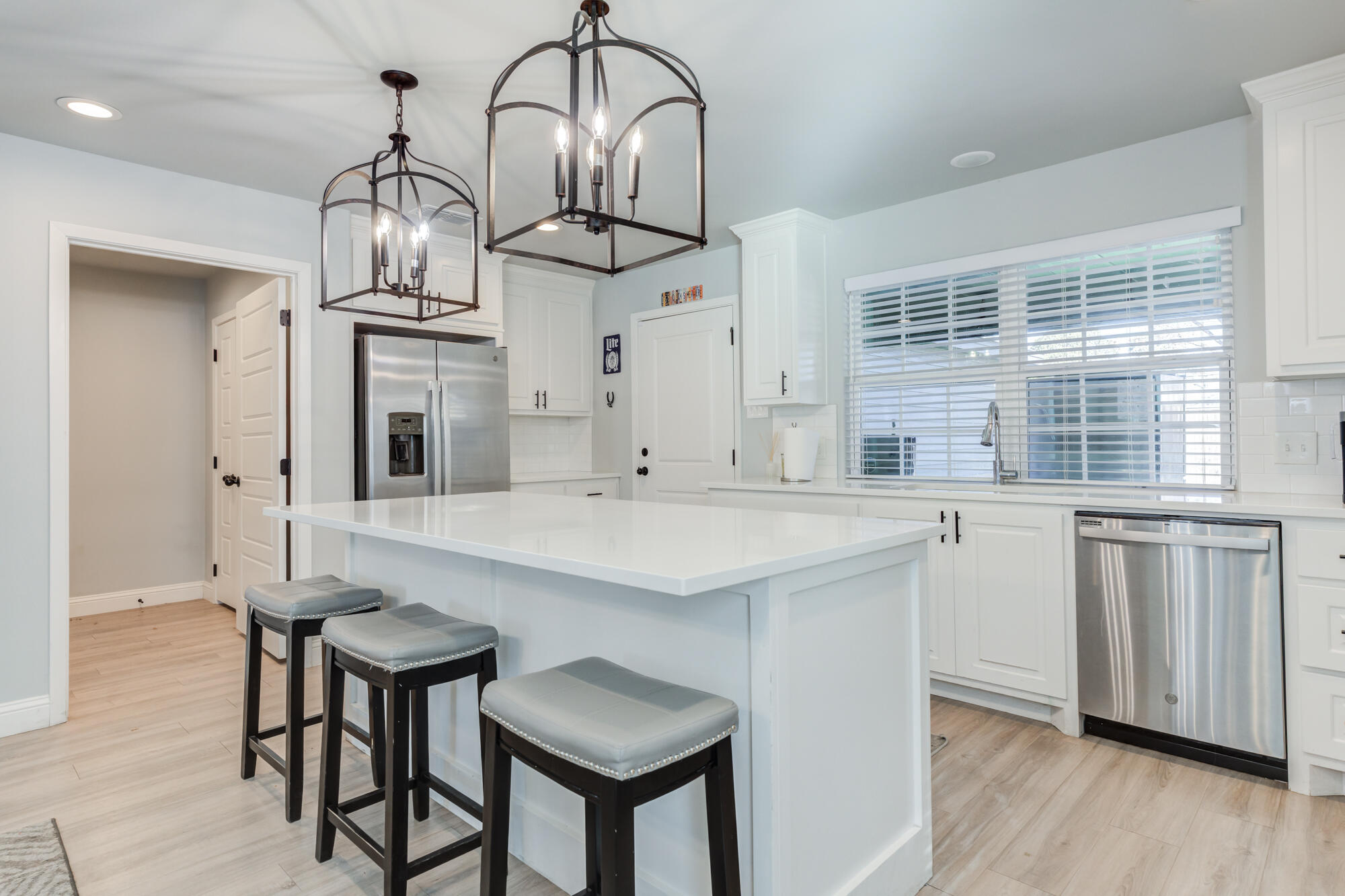 2414 25th Street Lubbock, TX 79411 - Photo 16 of 61 a kitchen with stainless steel appliances a dining table chairs and wooden floor