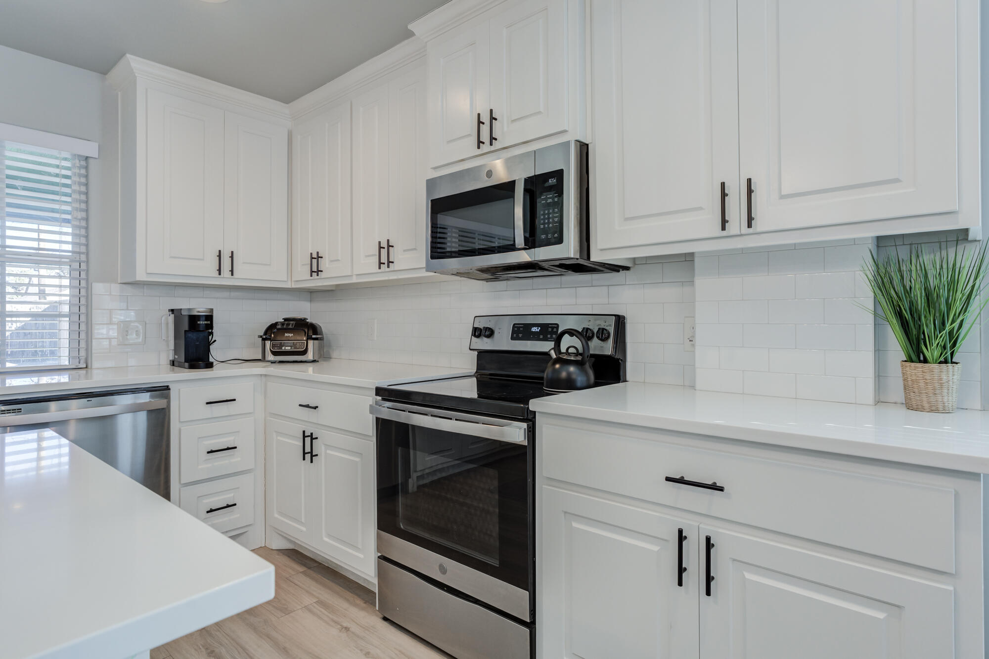 2414 25th Street Lubbock, TX 79411 - Photo 20 of 61 a kitchen with white cabinets stainless steel appliances and sink
