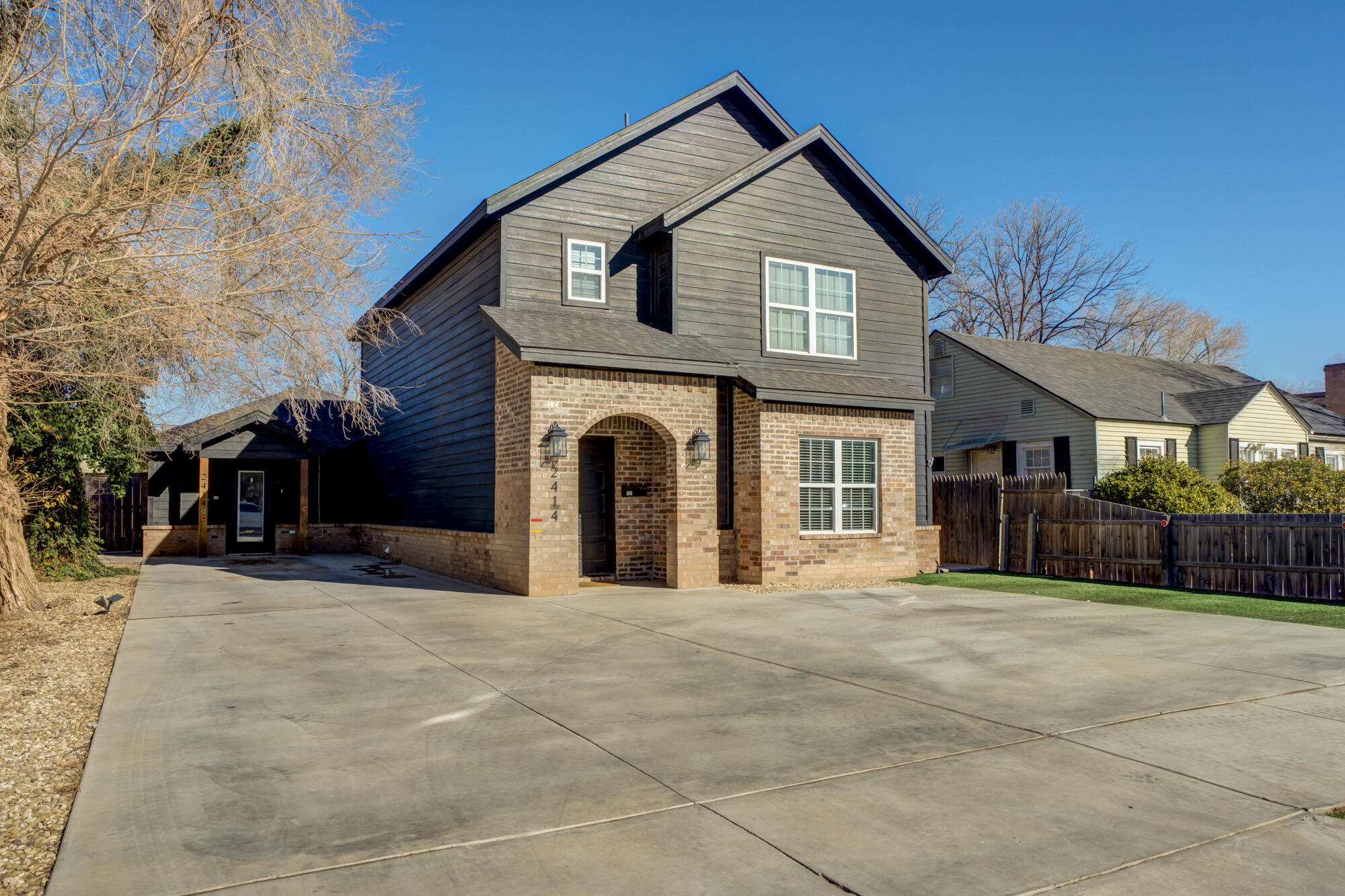 2414 25th Street Lubbock, TX 79411 - Photo 2 of 61 a view of a house with a big yard and large trees