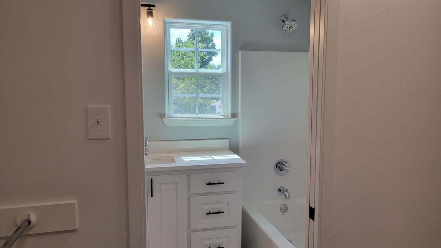 2414 25th Street Lubbock, TX 79411 - Photo 27 of 61 a bathroom with a sink a toilet and window