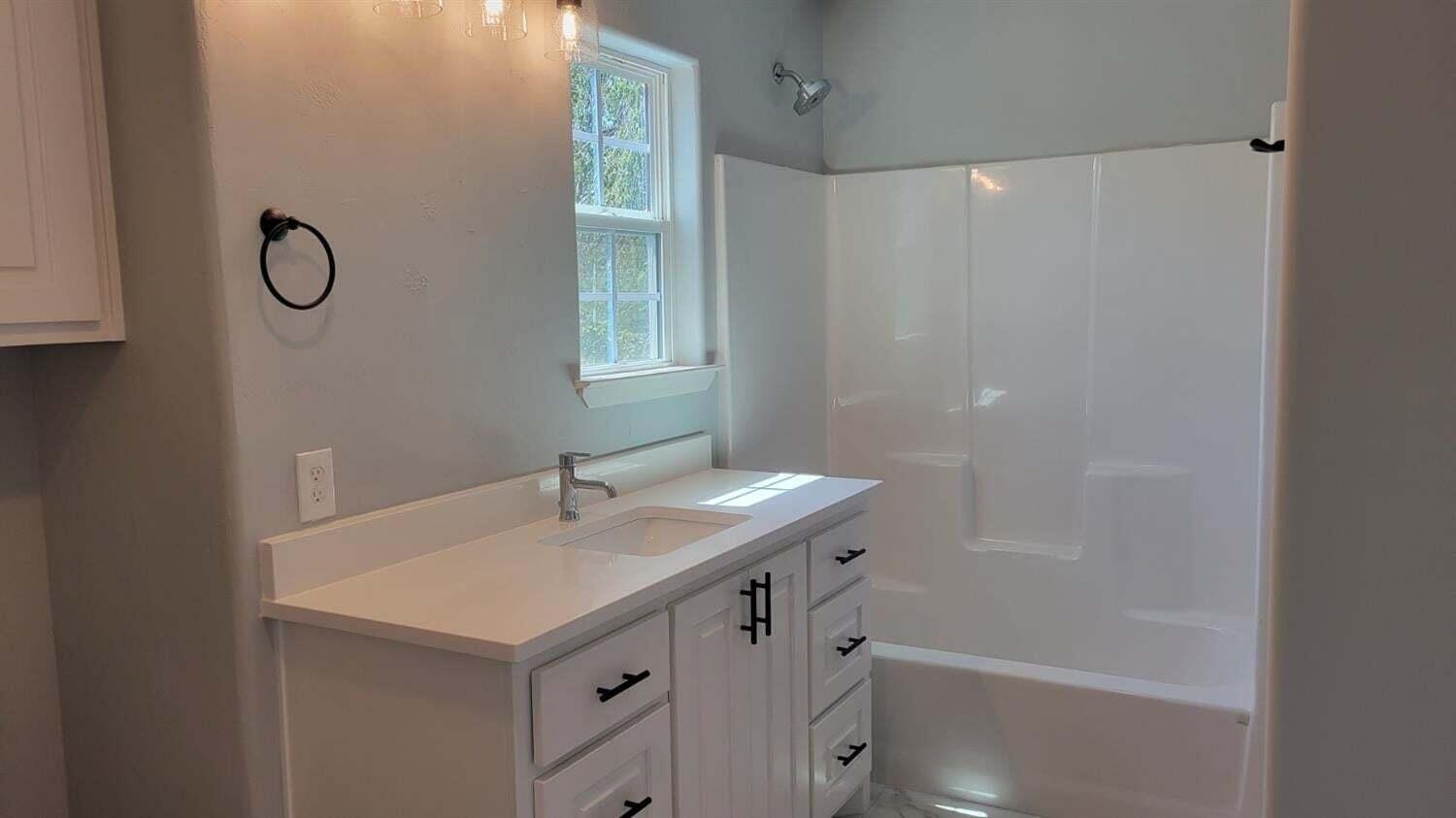 2414 25th Street Lubbock, TX 79411 - Photo 31 of 61 a bathroom with a sink a vanity and a mirror