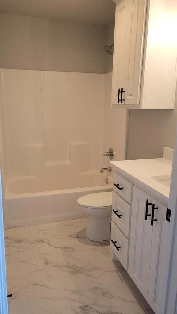 2414 25th Street Lubbock, TX 79411 - Photo 35 of 61 a bathroom with a sink a toilet and bathtub