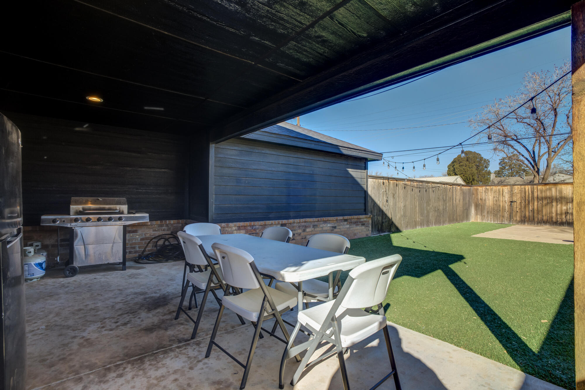 2414 25th Street Lubbock, TX 79411 - Photo 41 of 61 a backyard of a house with table and chairs