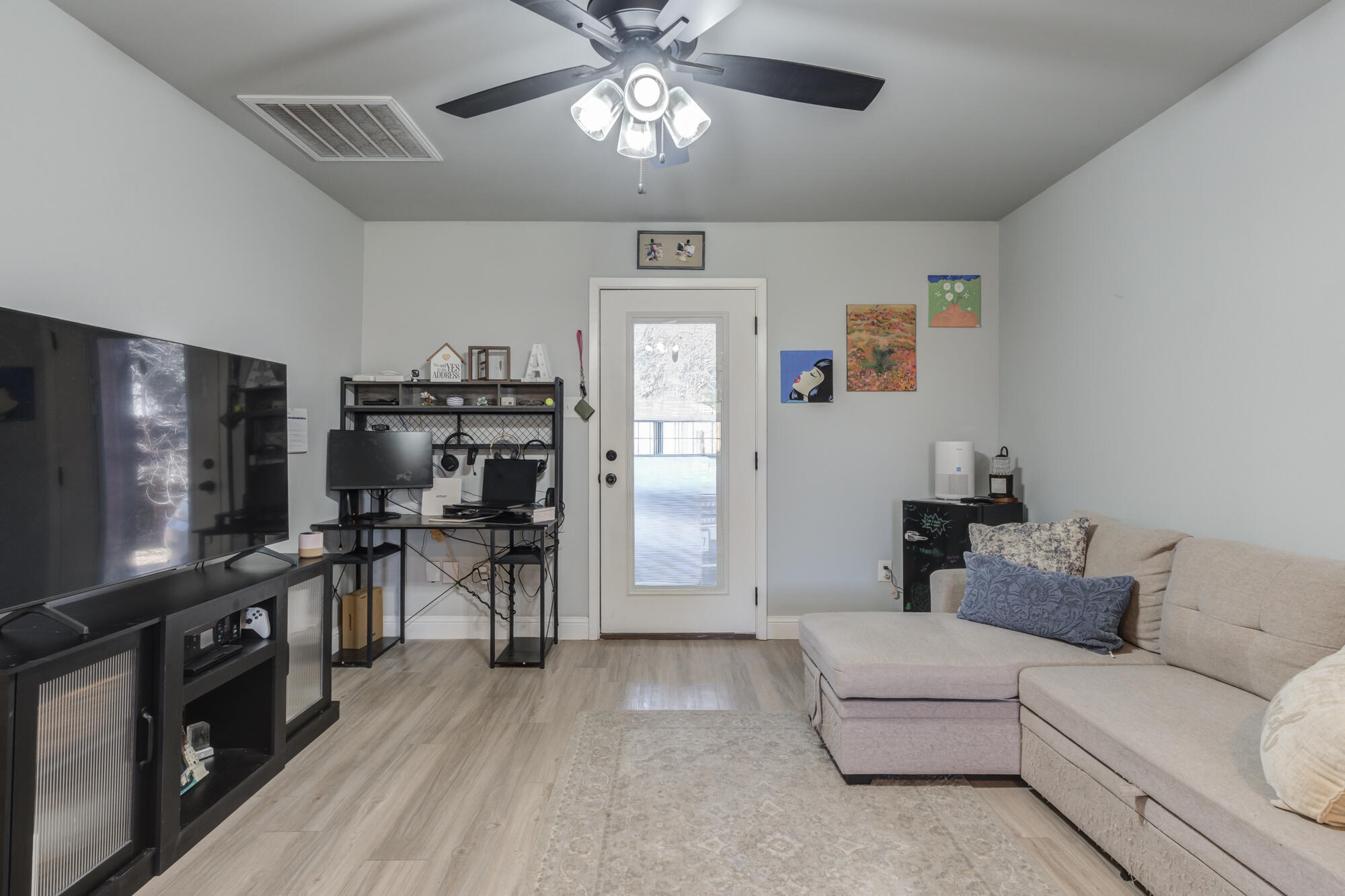 2414 25th Street Lubbock, TX 79411 - Photo 48 of 61 a living room with furniture and a flat screen tv