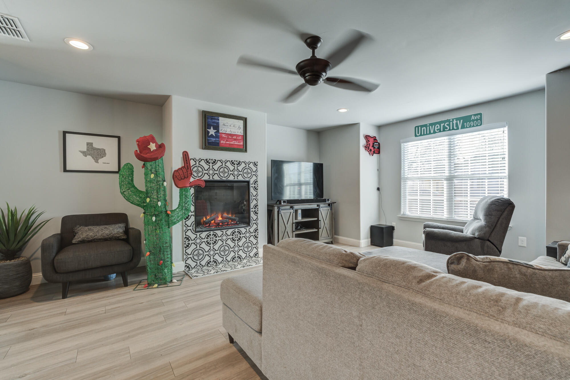 2414 25th Street Lubbock, TX 79411 - Photo 5 of 61 a living room with furniture a flat screen tv and a large window