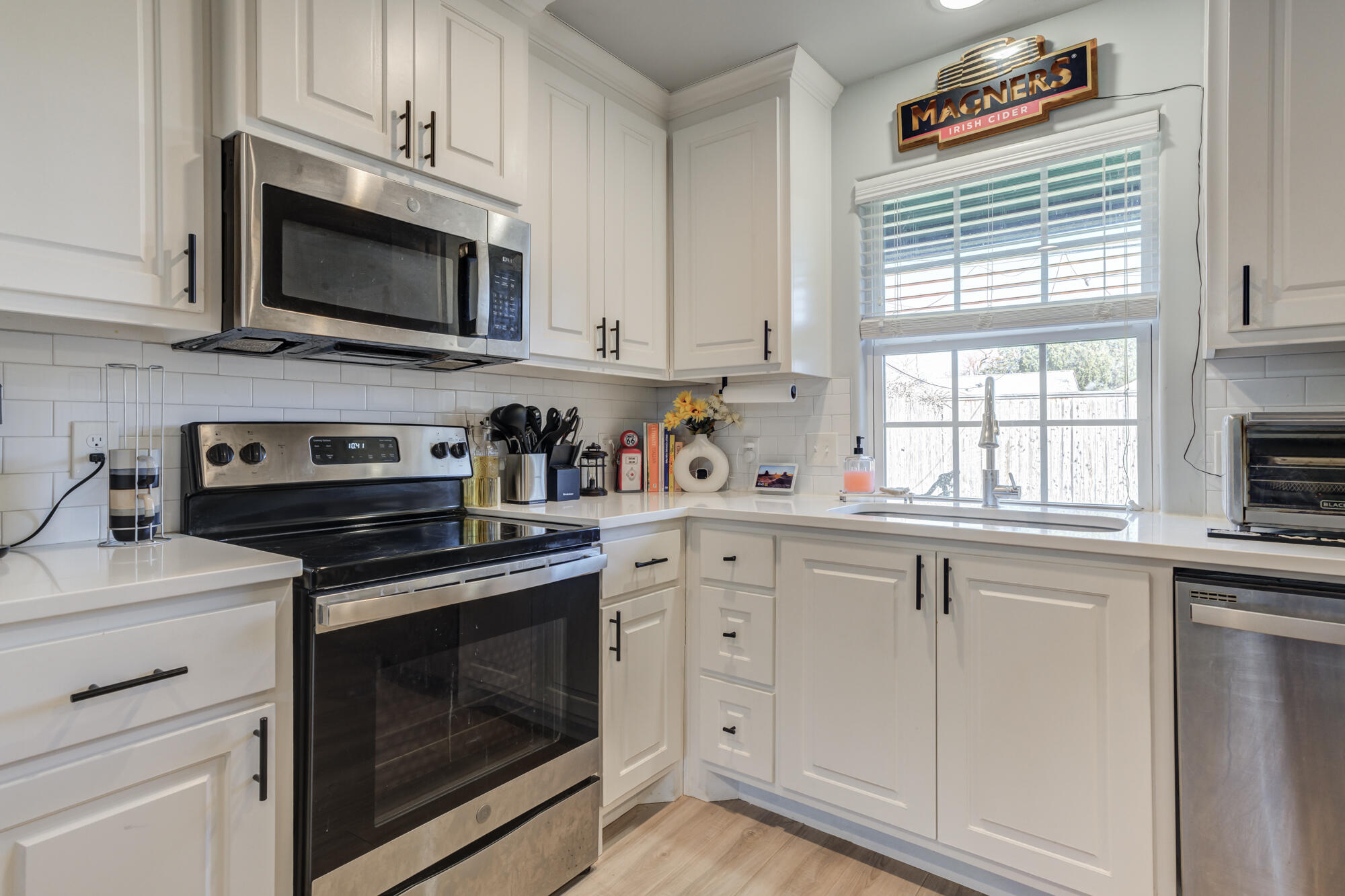 2414 25th Street Lubbock, TX 79411 - Photo 52 of 61 a kitchen with cabinets stainless steel appliances a sink and a window