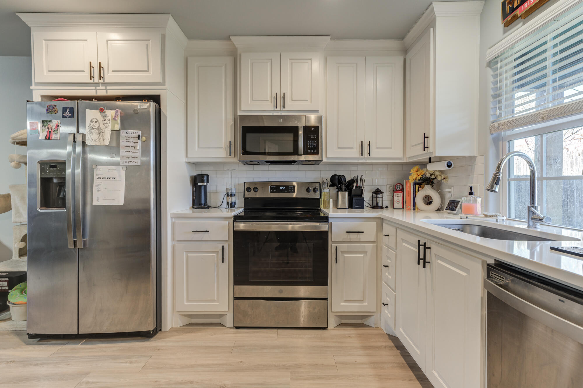 2414 25th Street Lubbock, TX 79411 - Photo 53 of 61 a kitchen with stainless steel appliances granite countertop a refrigerator stove and white cabinets