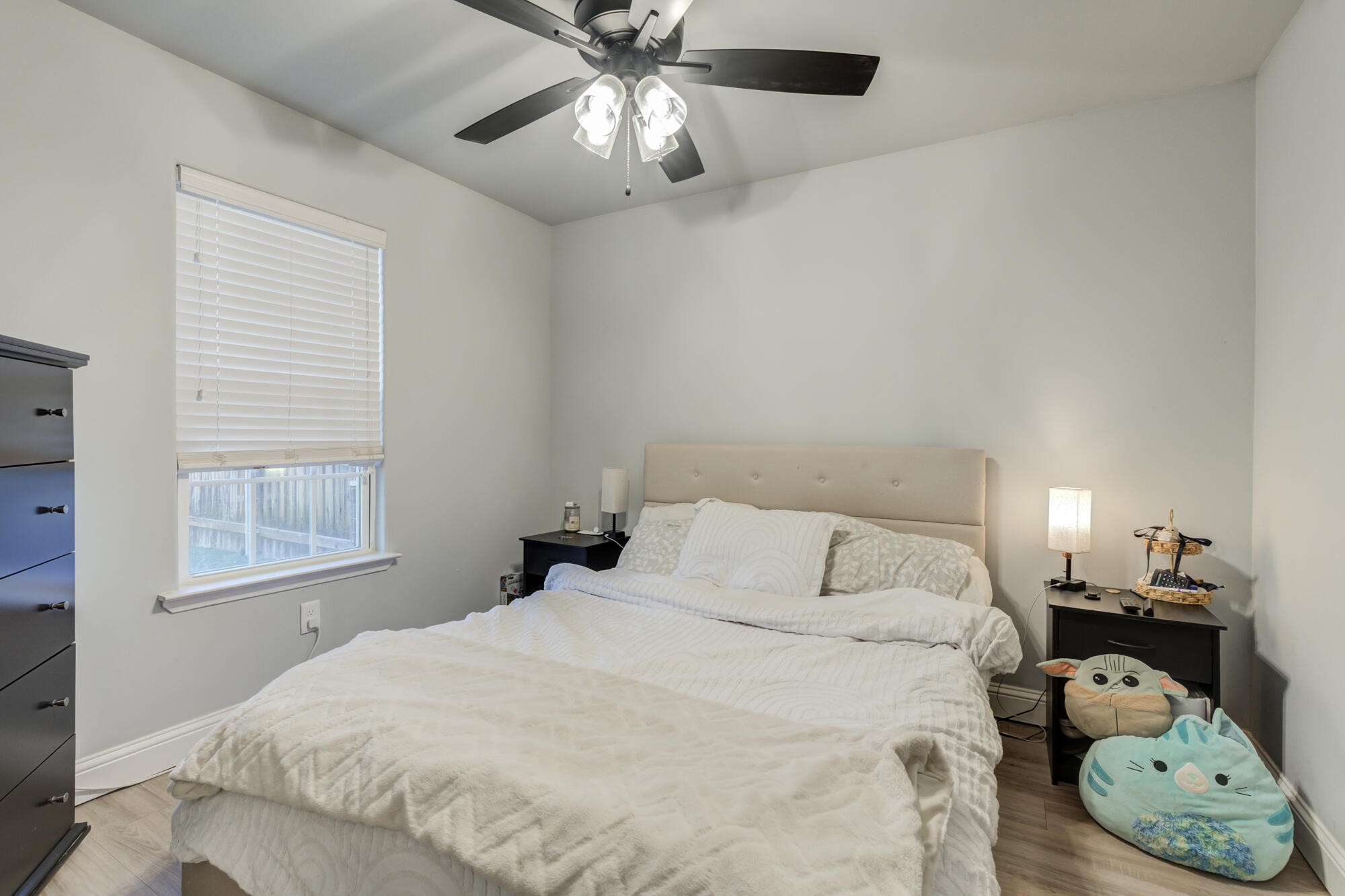 2414 25th Street Lubbock, TX 79411 - Photo 55 of 61 a bedroom with a bed and a chandelier