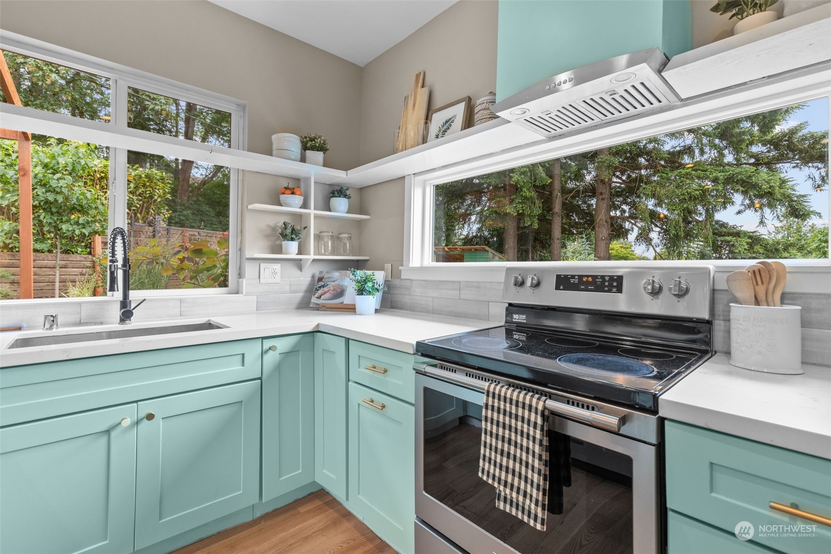 5503 Renton Avenue South Seattle, WA 98118 - Photo 8 of 39 a kitchen with a stove a sink and wooden cabinets