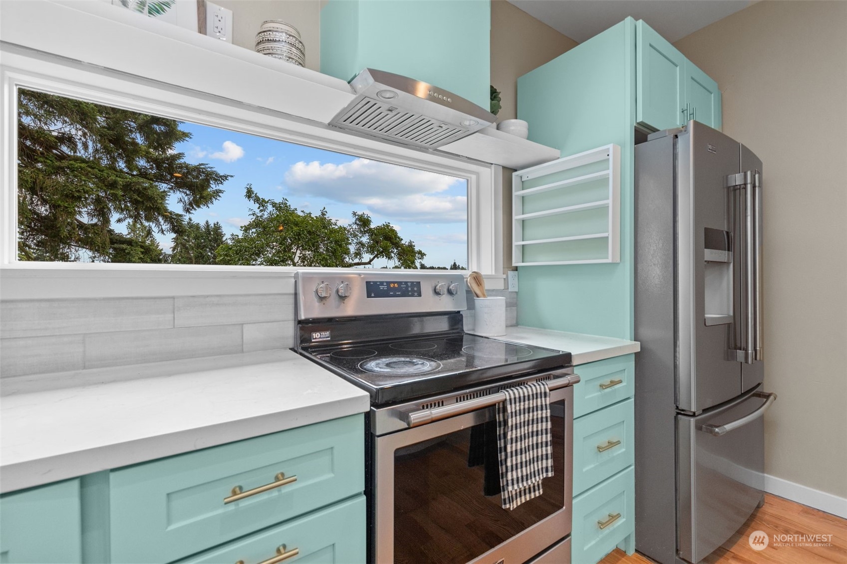 5503 Renton Avenue South Seattle, WA 98118 - Photo 9 of 39 a kitchen with stainless steel appliances granite countertop a refrigerator and a stove