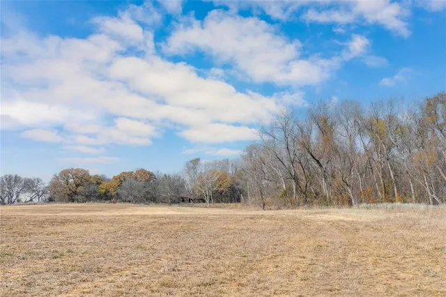 a aerial view of a house with a yard and lake view