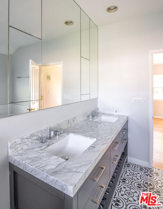 11144 Valley Spring Place Studio City, CA 91602 - Photo 19 of 36 a bathroom with a granite countertop sink and a mirror