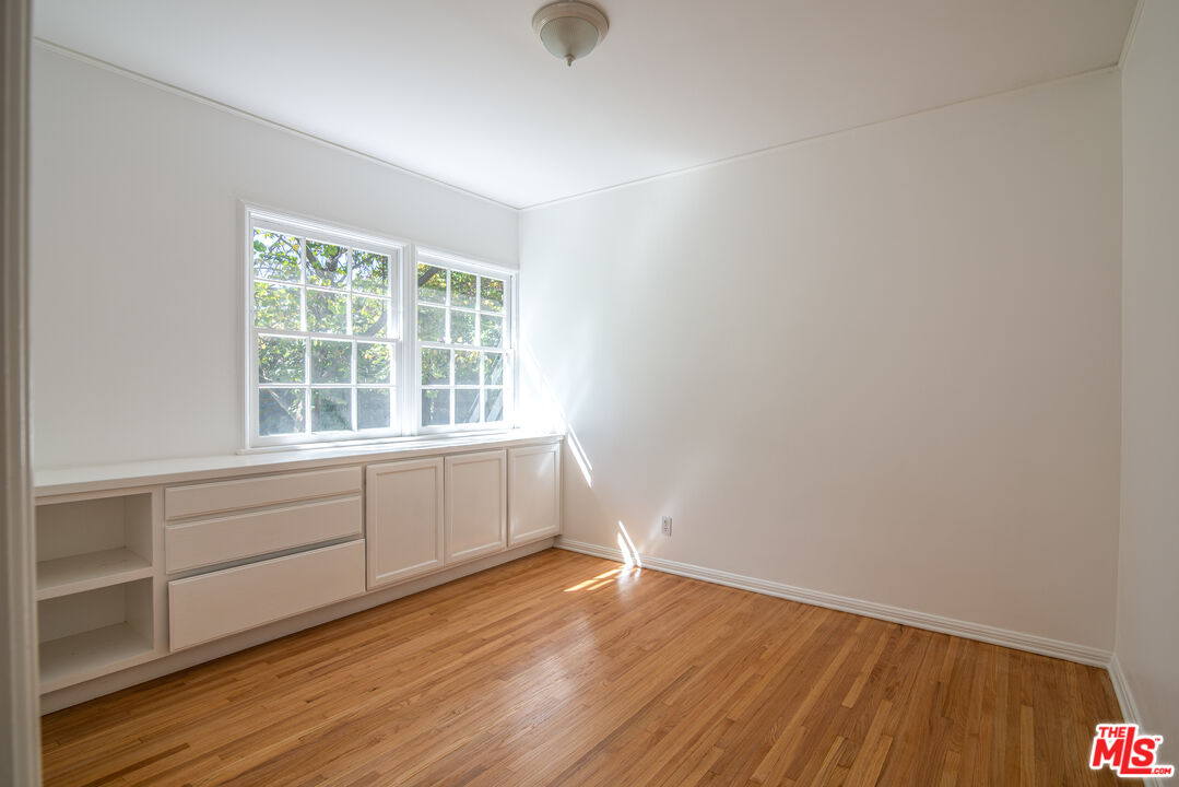 11144 Valley Spring Place Studio City, CA 91602 - Photo 22 of 36 a view of an empty room with wooden floor and a window