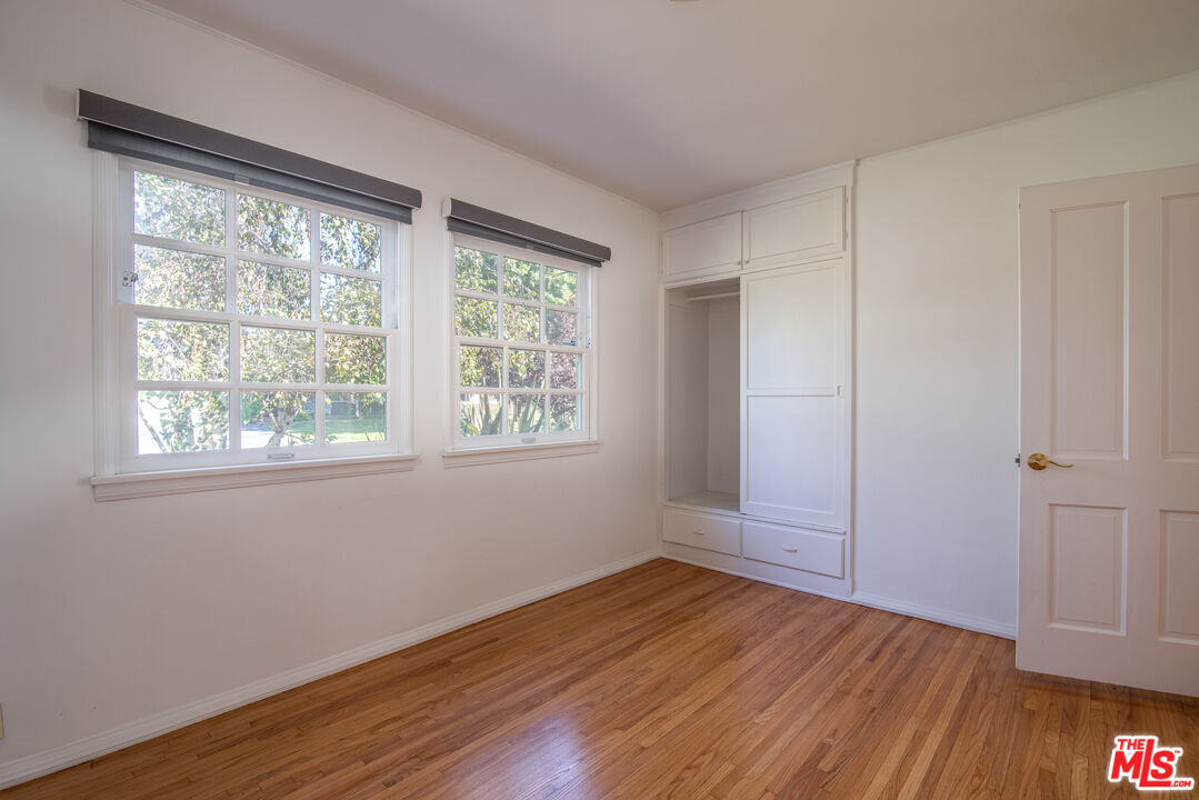 11144 Valley Spring Place Studio City, CA 91602 - Photo 27 of 36 a view of an empty room with wooden floor and a window