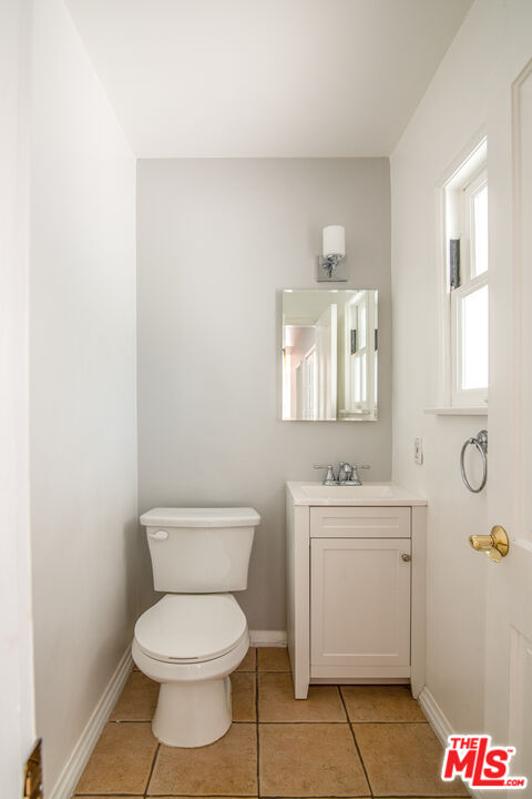 11144 Valley Spring Place Studio City, CA 91602 - Photo 28 of 36 a bathroom with a toilet a sink and mirror