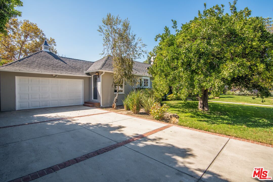 11144 Valley Spring Place Studio City, CA 91602 - Photo 36 of 36 a front view of a house with a yard and garage