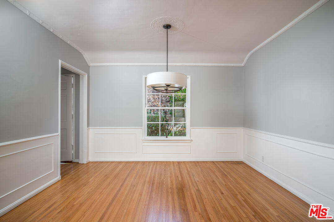 11144 Valley Spring Place Studio City, CA 91602 - Photo 7 of 36 a view of an empty room with wooden floor and a window