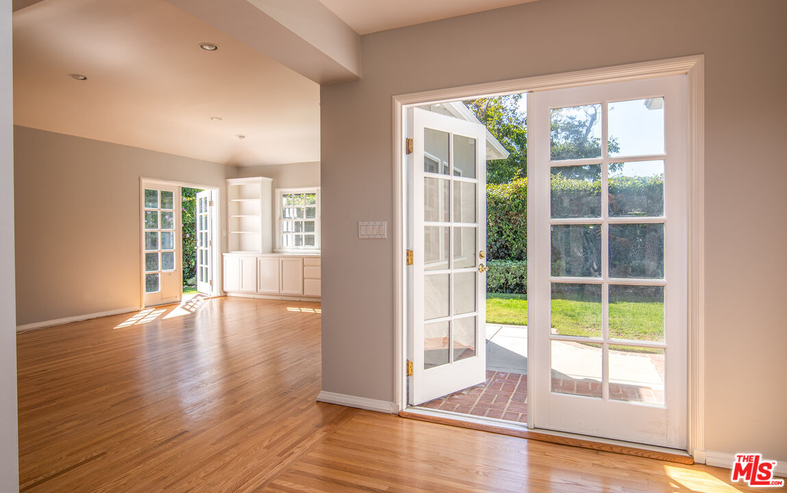 11144 Valley Spring Place Studio City, CA 91602 - Photo 8 of 36 a view of an empty room with wooden floor and a window