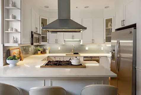 a kitchen with a refrigerator and a stove top oven