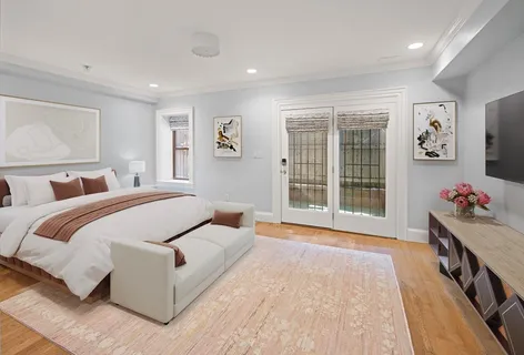 a spacious bedroom with a large bed and a window