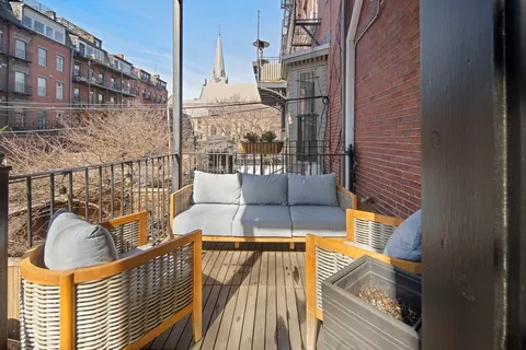 a view of balcony with furniture