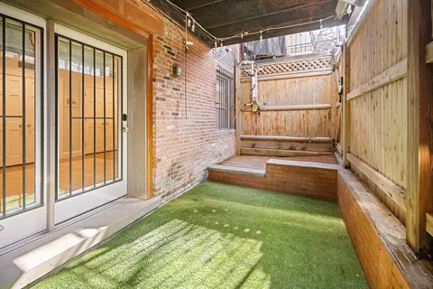 a backyard of a house with outdoor seating