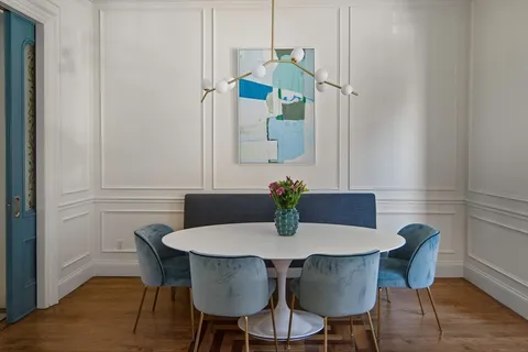 a view of a dining room with furniture and wooden floor