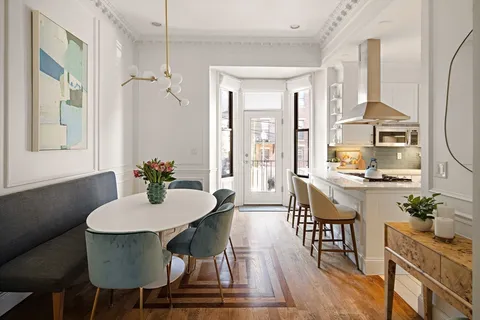 a view of a dining room with furniture window and wooden floor