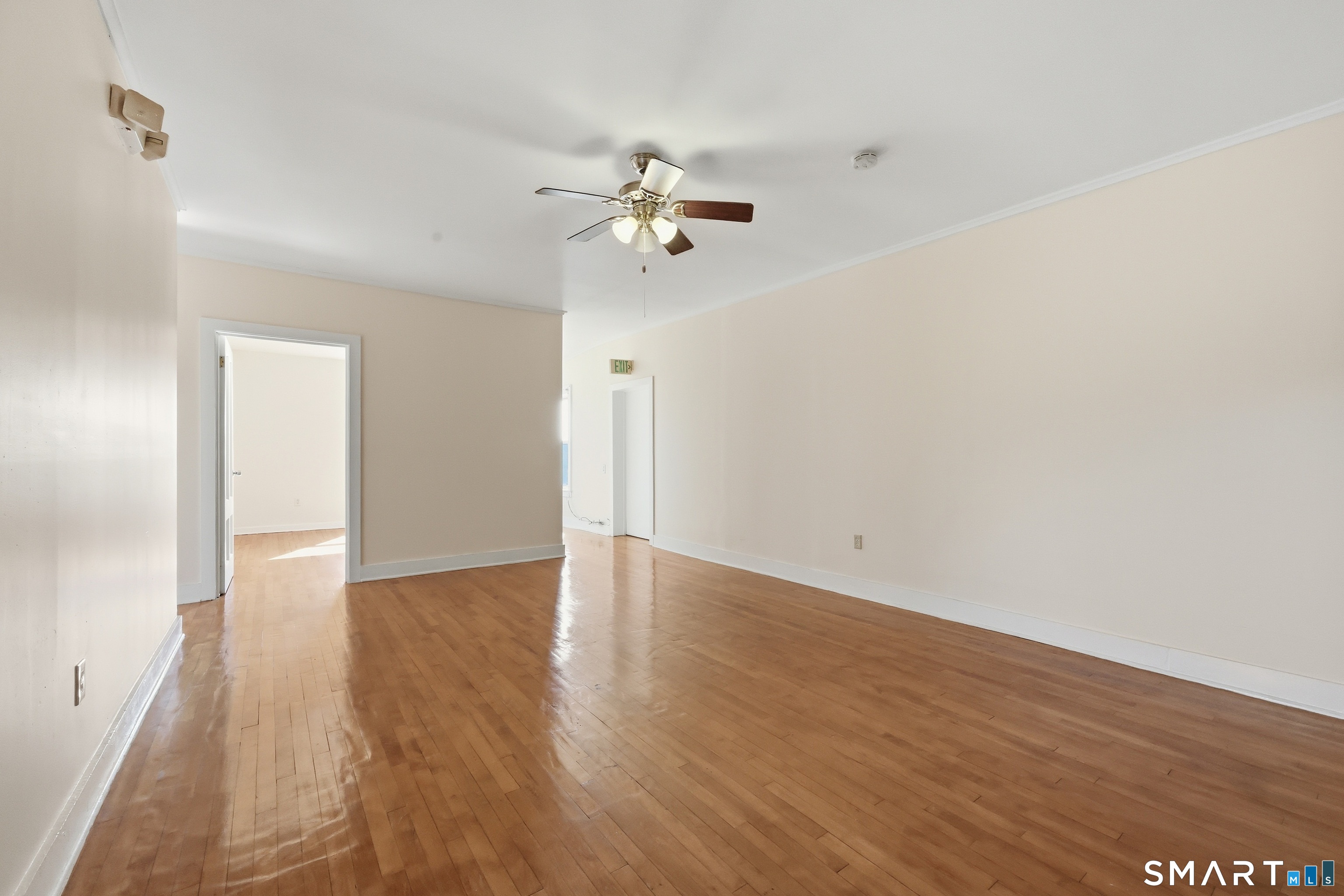 360 Main Street, Unit 3B Middletown, CT 06457 - Photo 20 of 21 an empty room with wooden floor ceiling fan and window