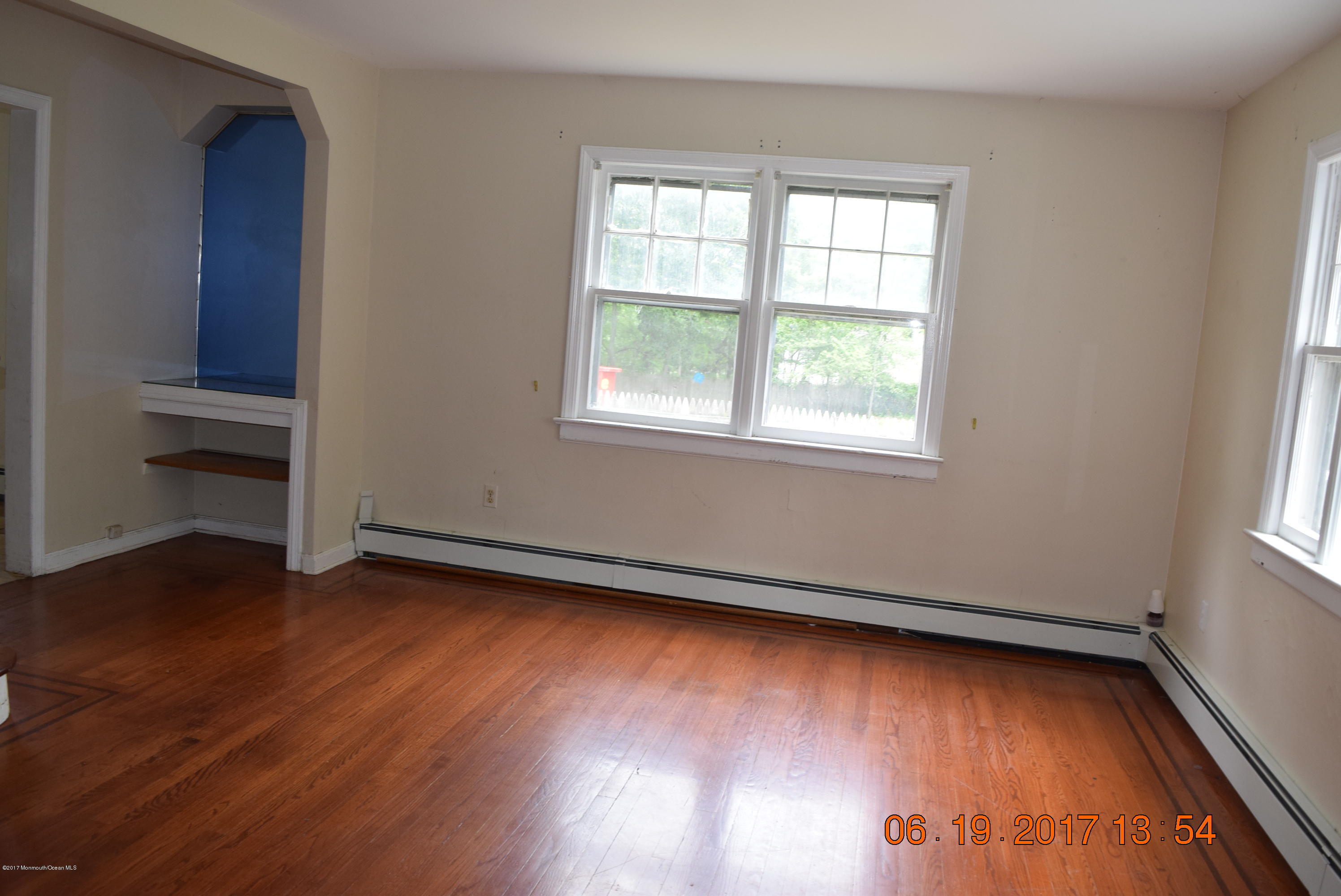 636 West Farms Road Howell, NJ 07731 - Photo 5 of 17 an empty room with wooden floor and windows