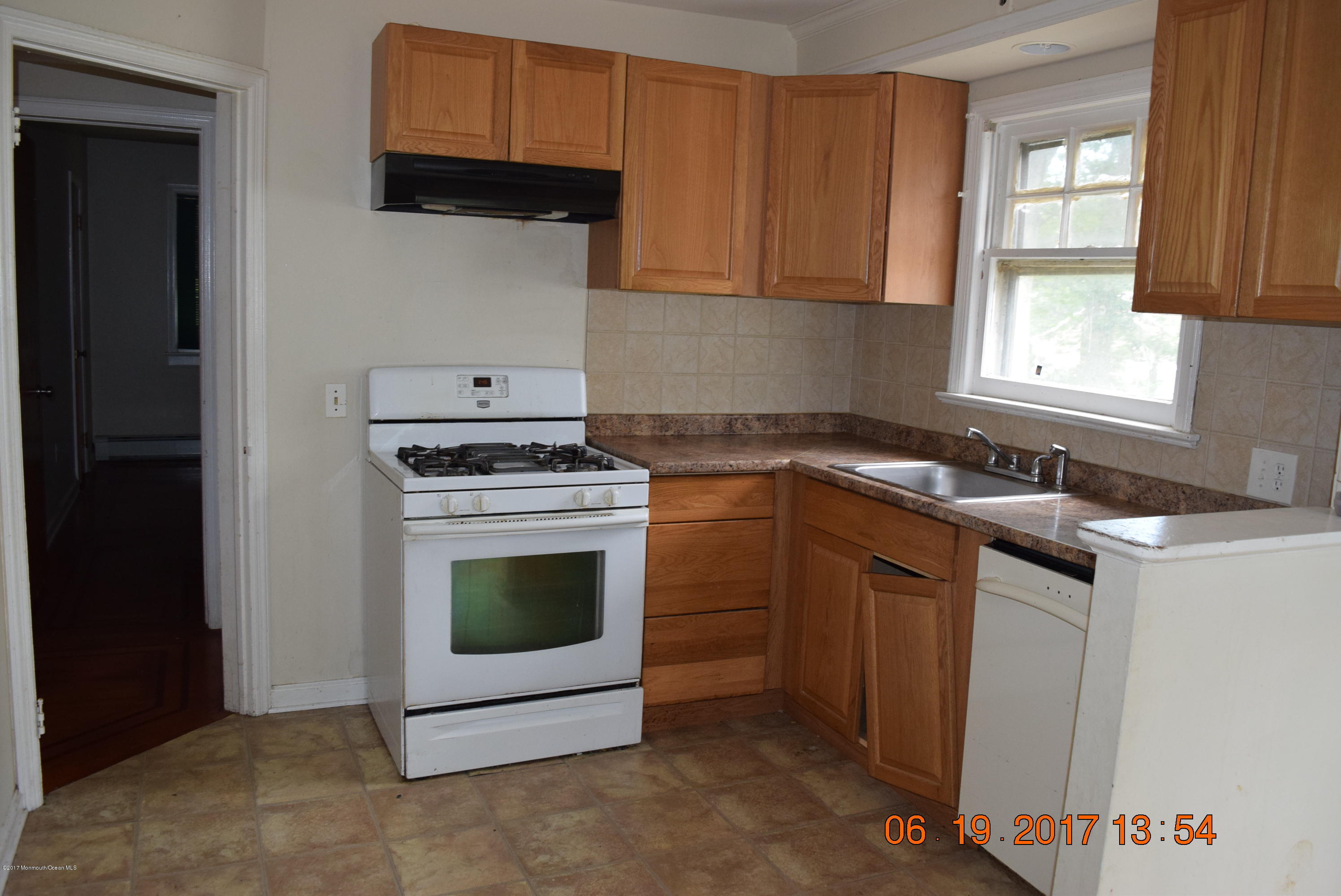 636 West Farms Road Howell, NJ 07731 - Photo 7 of 17 a kitchen with granite countertop white cabinets and white appliances