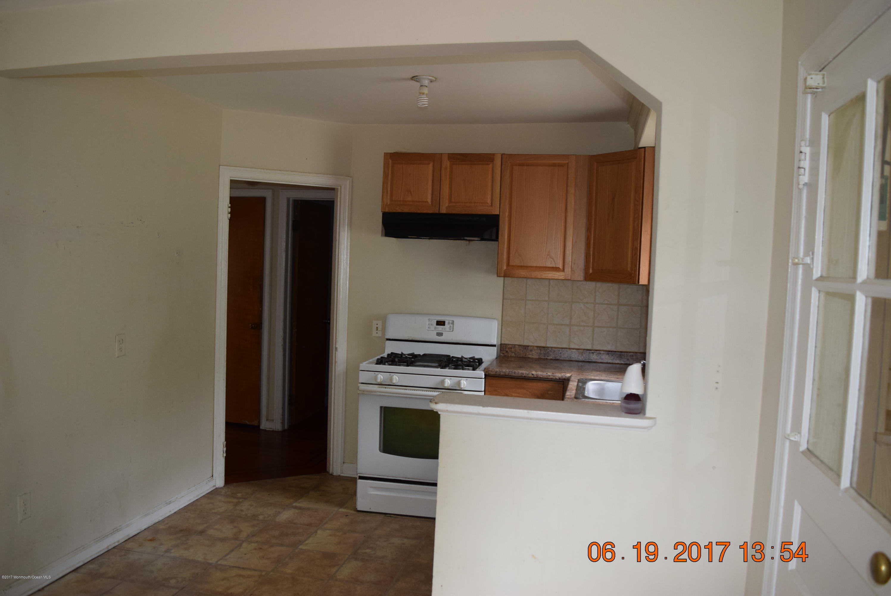 636 West Farms Road Howell, NJ 07731 - Photo 8 of 17 a kitchen with granite countertop a stove and a refrigerator