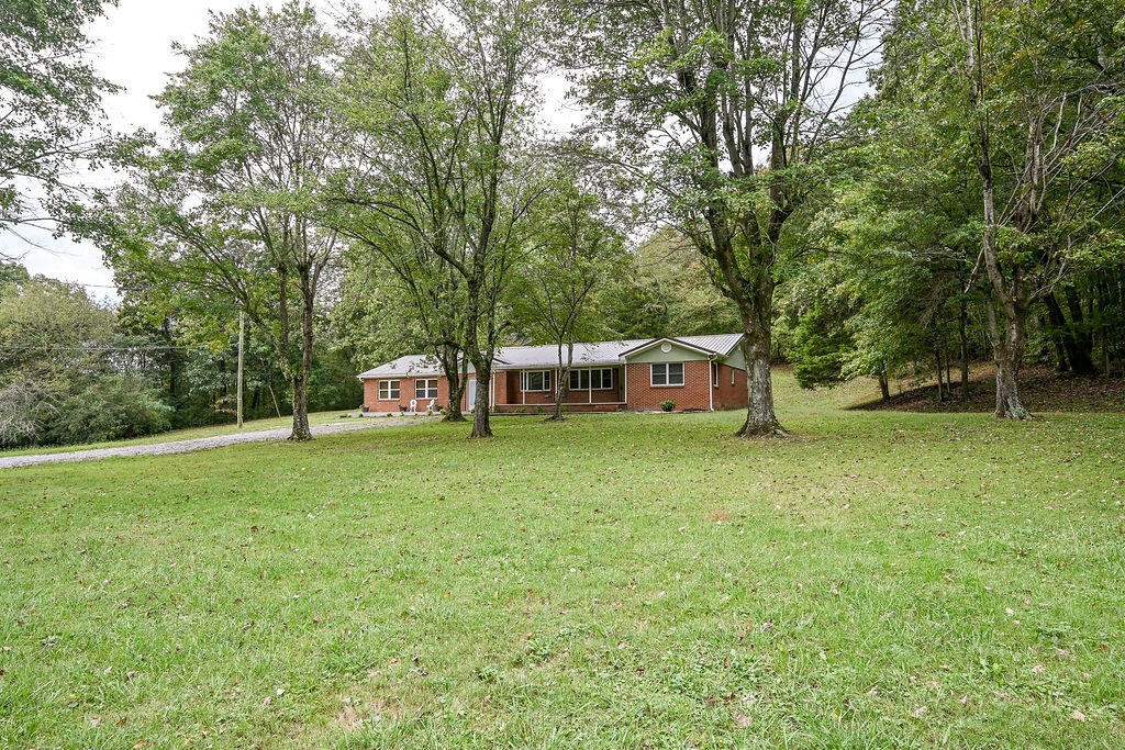5024 Spring Place Road Southeast Cleveland, TN 37323 - Photo 3 of 43 a front view of a house with a garden