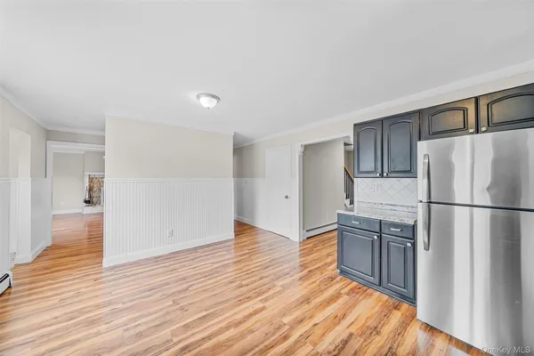 a view of a refrigerator in kitchen and wooden floor